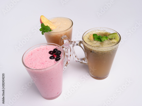 Glass of pink strawberry milkshake or cocktail isolated on white background.