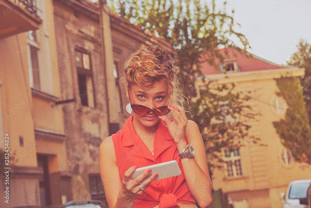 Attractive woman using cellphone on the street.