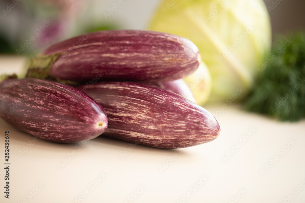 Closeup view of small purple Asian eggplants, food background photography. Pile of fresh eggplants at Indian market, vegetarian food. Above small Asian purple eggplants, ecology and nature concept Closeup view of small purple Asian eggplants, food background photography. Pile of fresh eggplants at Indian market, vegetarian food. Above small Asian purple eggplants, ecology and nature concept