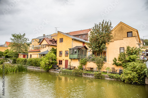 a picturesque canal along old yellow houses