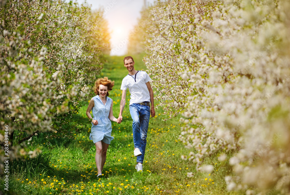 Fototapeta premium Young couple have fun in the garden