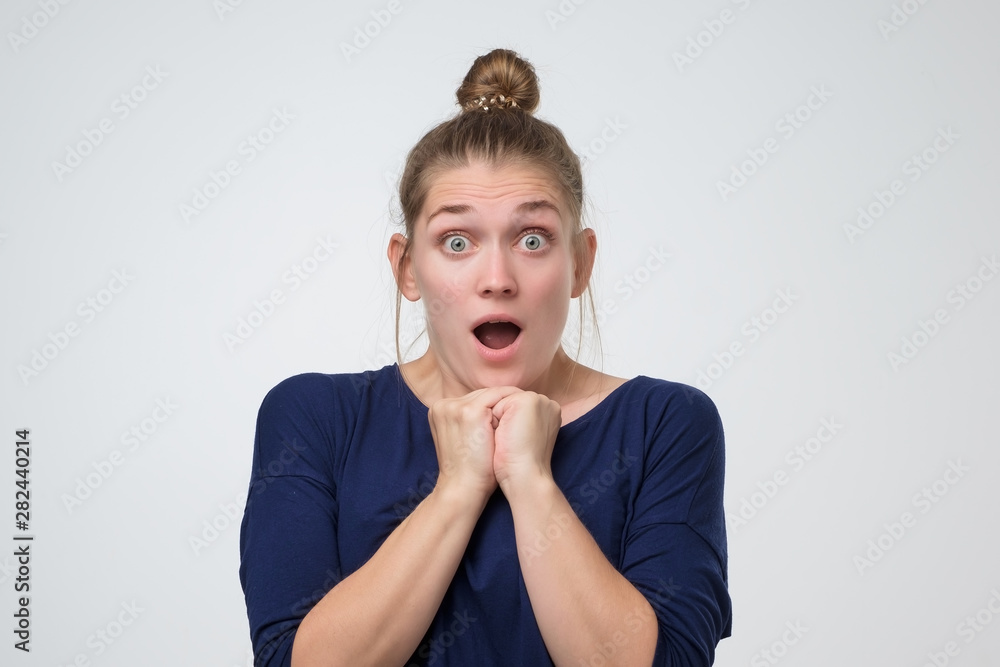 Φωτογραφία Woman with hair bun standing with open mouth shocked with the latest news