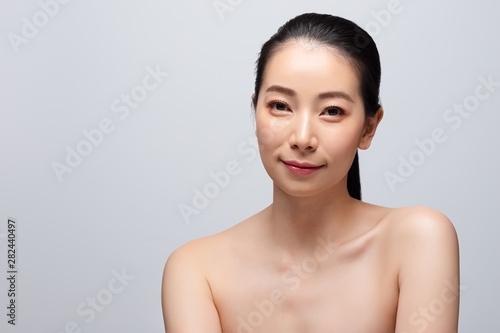 Portrait of beautiful young asian woman clean fresh bare skin concept. Asian girl beauty face skincare and health wellness, Facial treatment, Perfect skin, Natural make up. Isolated on gray background