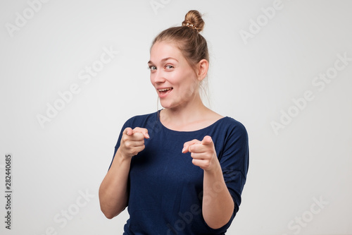 Foto Woman pointing with fingers at camera choosing you.