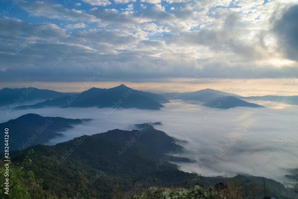 Mountain view morning of top hill around with sea of mist in valley with cloudy sky background, sunrise at Pha Tang, Chiang Rai, northern of Thailand. Mountain view morning of top hill around with sea of mist in valley with cloudy sky background, sunrise at Pha Tang, Chiang Rai, northern of Thailand.