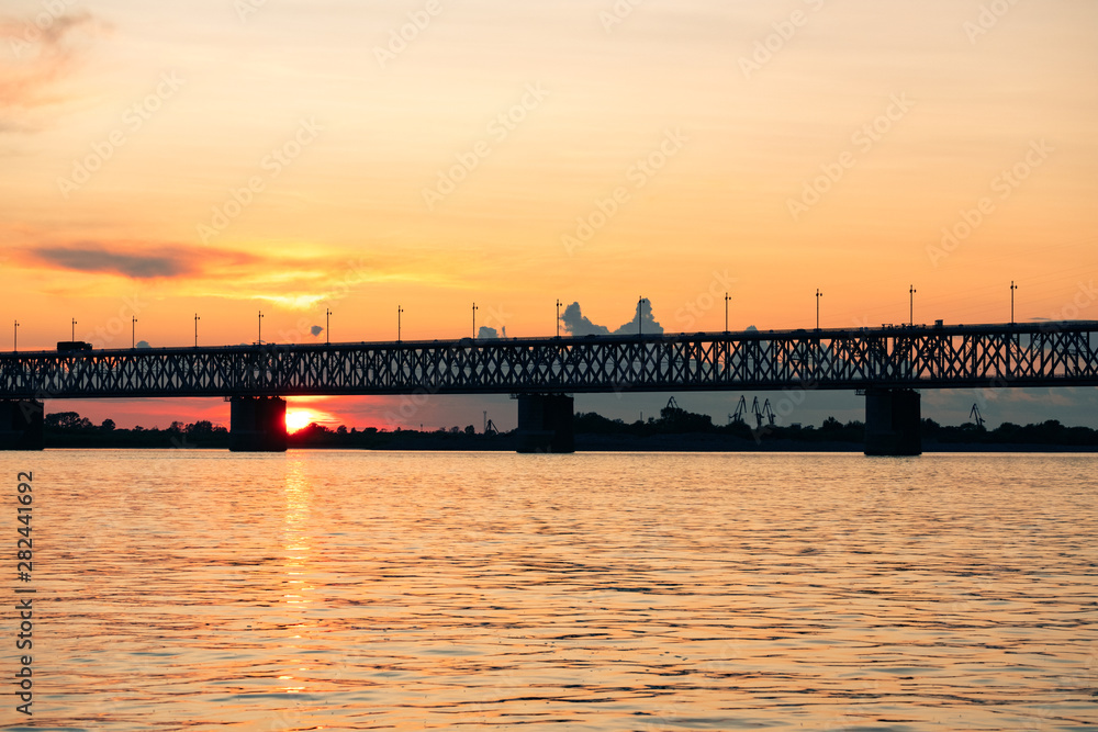 Bridge over the Amur river at sunset. Russia. Khabarovsk. Photo from the middle of the river.