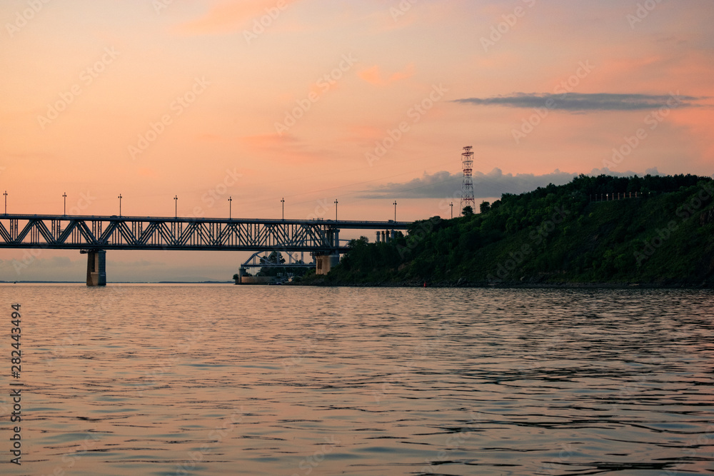 Bridge over the Amur river at sunset. Russia. Khabarovsk. Photo from the middle of the river.