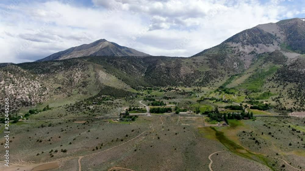 Aerial top view of green land and mountain in the background in Aspen Springs, Sierra Nevada, Mono County California, USA Aerial top view of green land and mountain in the background in Aspen Springs, Sierra Nevada, Mono County California, USA