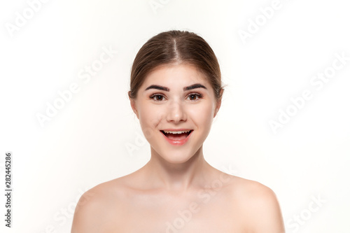 Close-up portrait of a happy beautiful young girl isolated over white background.