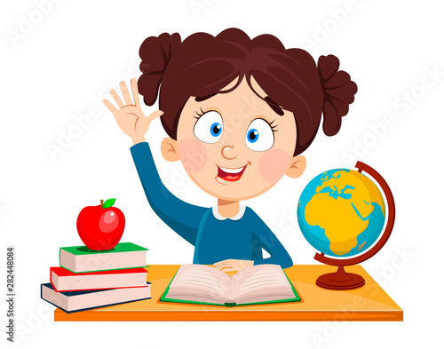 Cute schoolgirl sitting at the desk.
