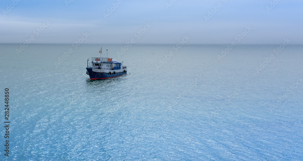 Obraz premium view of a small lonely ship sailing on Lake Baikal