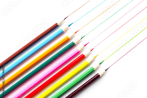 School color pencils with drawn colored lines isolated on white background. Top view. © Lyubov