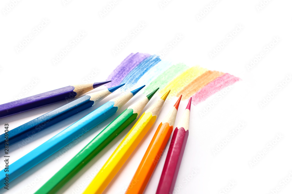 Color pencils with rainbow drawing isolated on white background. Top view.
