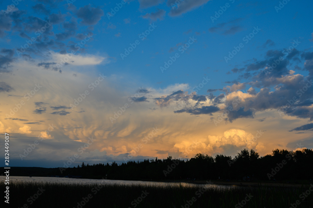 dramatic sunlit storm clouds over lake dramatic sunlit storm clouds over lake