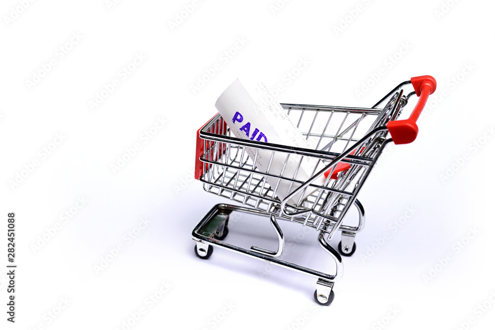Paid Shopping Receipts in shopping trolley isolated on white background.