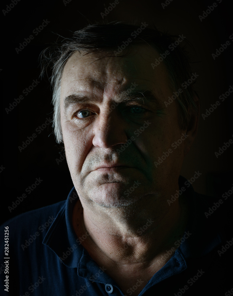 Obraz premium Old man portrait on black background.