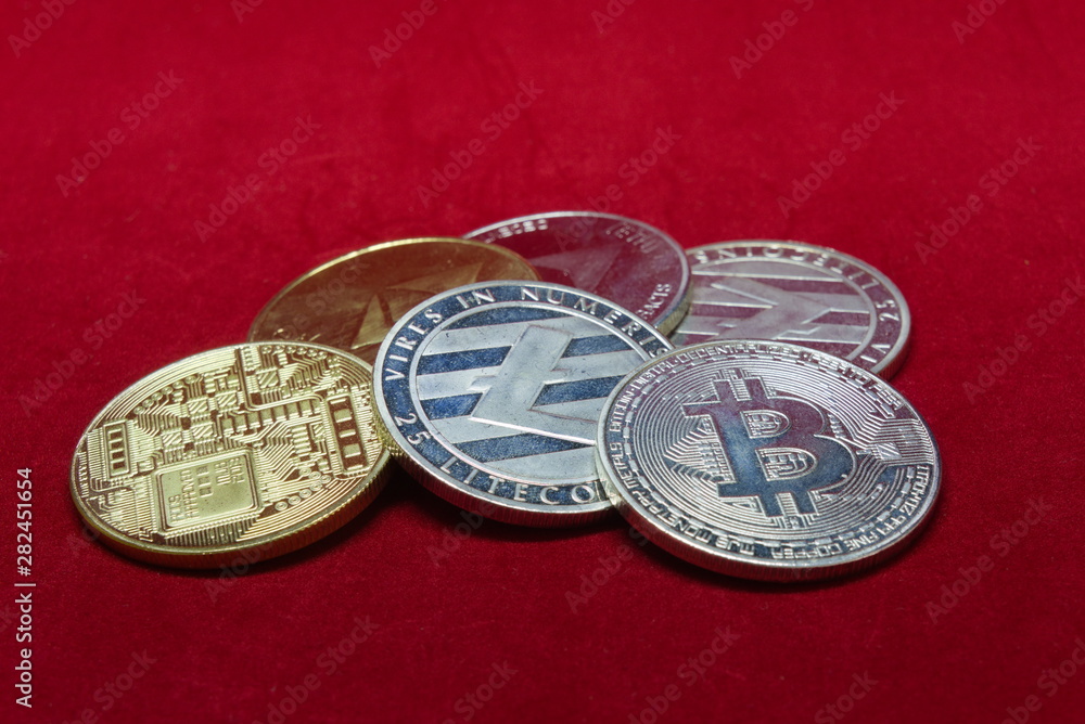 close up of silver and gold cryptocurrency with a red velvet background set up in a circle close up of silver and gold cryptocurrency with a red velvet background set up in a circle