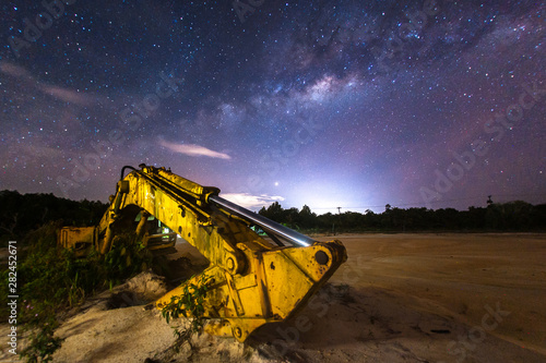 excavator at work and milky way