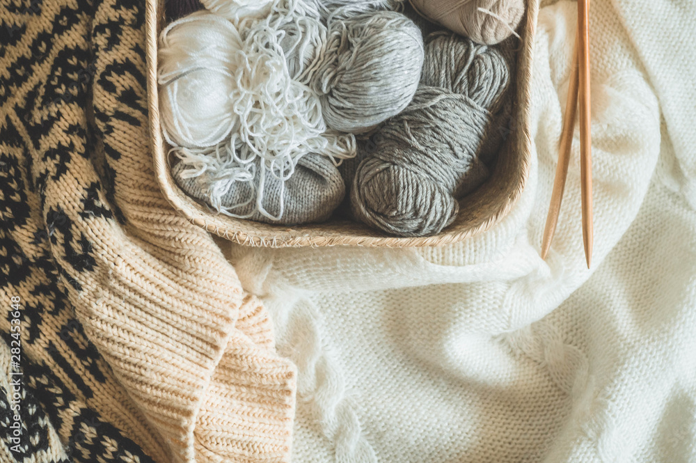 Thread for knitting in a basket closeup. Knitting as a hobby. Accessories for knitting. Thread for knitting in a basket closeup. Knitting as a hobby. Accessories for knitting.