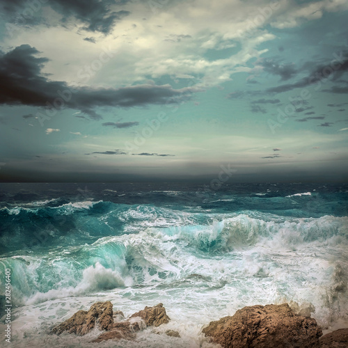 Fototapeta Naklejka Na Ścianę i Meble -  Stormy sea view  near coastline at evening time. Waves, splashed