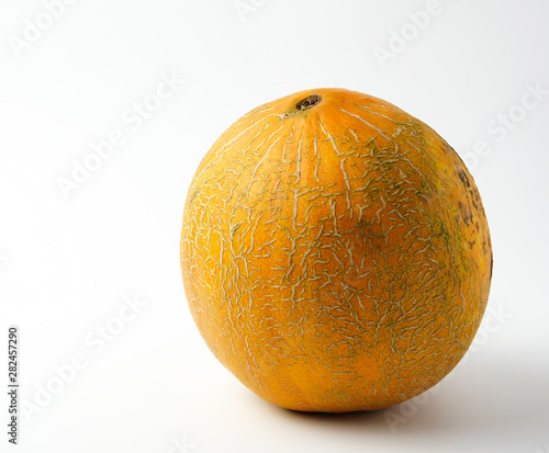 whole ripe yellow melon on a white background