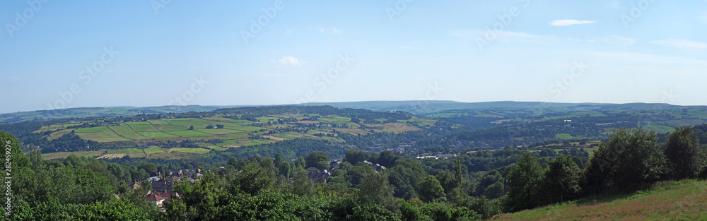 a long panoramic scenic view of west yorkshire countryside with the village of luddenden at the bottom of the calder valley with buildings surrounded by farms and fields a long panoramic scenic view of west yorkshire countryside with the village of luddenden at the bottom of the calder valley with buildings surrounded by farms and fields