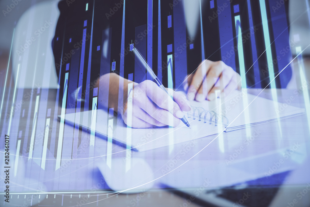 Forex graph on hand taking notes background. Concept of research. Multi exposure Forex graph on hand taking notes background. Concept of research. Multi exposure