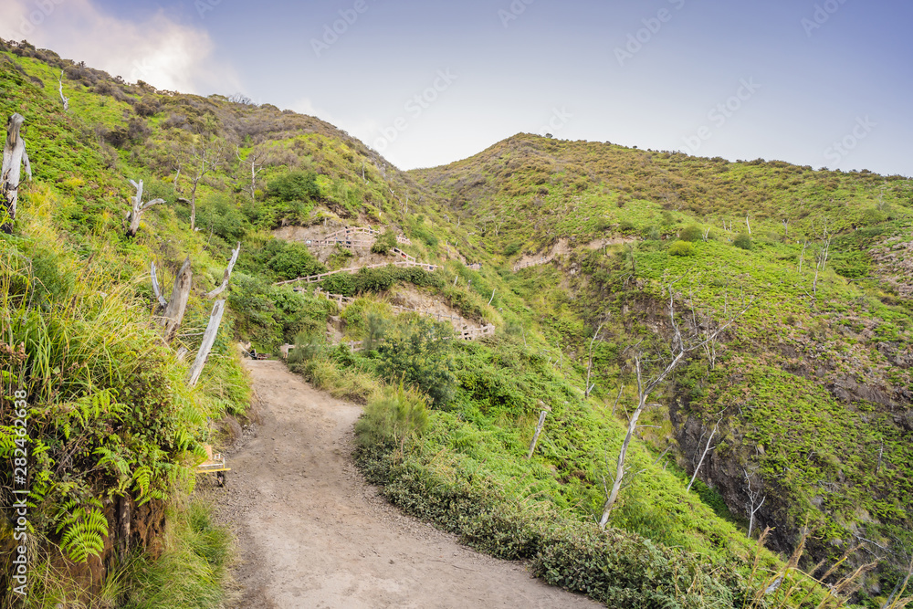 The magnificent views on green mountains from a mountain road trecking to the Ijen volcano or Kawah Ijen on the Indonesian language. Famous volcano containing the biggest in the world acid lake and