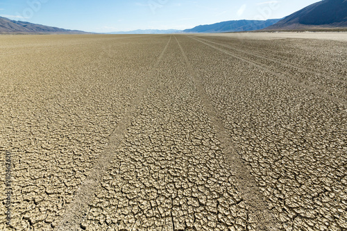 Tire tracks running across the black rock desert playa