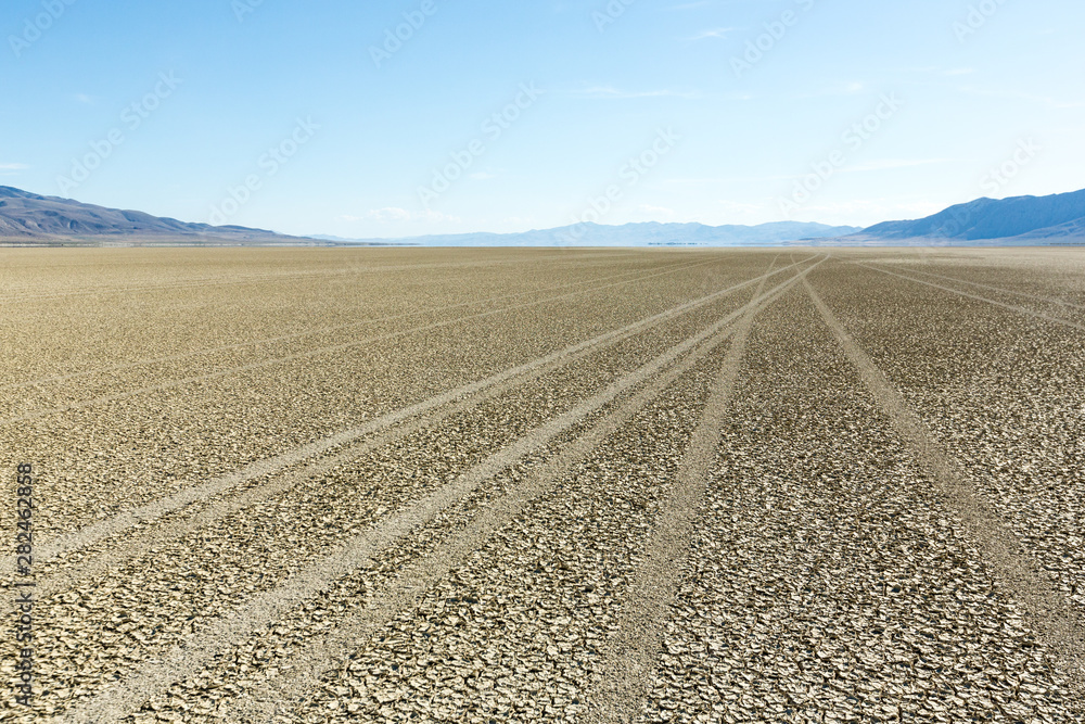 Tire tracks running across the black rock desert playa Tire tracks running across the black rock desert playa