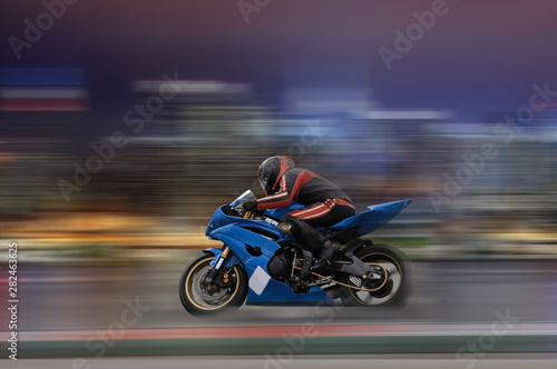 Motorcycle rider racing at high speed