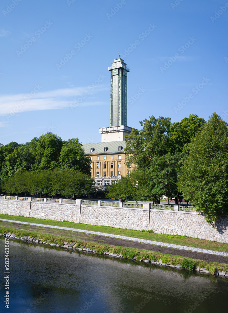 Ostravice river, Komenskeho sady park, Ostrava, Czech Republic / Czechia - nature of park in the city center. Tower and building of New Town hall