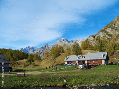 A mountain pasture with its typical houses immersed in the Nature of the Natural Park "Alpe Veglia and Devero", in the Italian Alps, near the town of Domodossola - October 2018.