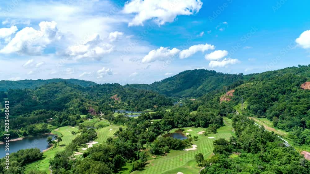 Drone Hyperlapse of Golf course with clear blue sky White clouds flowing in the sky 4K Time Lapse nature Footage Drone Hyperlapse of Golf course with clear blue sky White clouds flowing in the sky 4K Time Lapse nature Footage