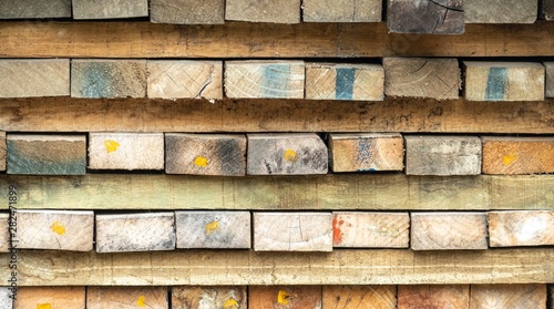 Chopped firewood, stacked woodfuel, fuelwood texture. Natural wooden background.