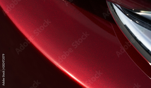 Close up detail of red metallic paint coating car body © jamesteohart