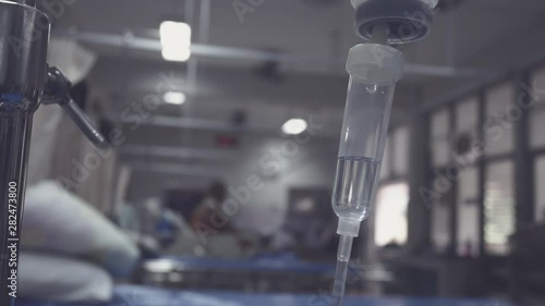 IV infusion. Liquid saline is slowly dripping drops of drugs, medicine or antibiotic therapy and surgery recovery in a hospital or clinic