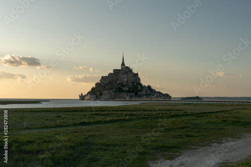 Mont Saint Michel view with fields and sunset