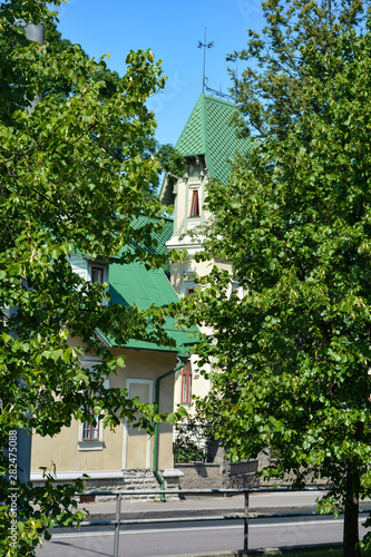 House hid behind trees on a city street, Tallinn, Estonia