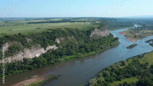 Wallpaper Mural The copter follows the river and filming rocky mountains and small village in the island. Ural open spaces with its meadows and forests in the background. Torontodigital.ca
