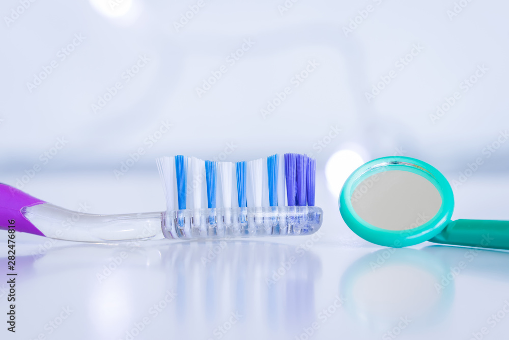 toothbrush with mouth mirror on white background toothbrush with mouth mirror on white background