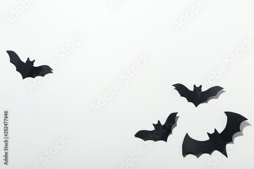 Halloween paper bats on whi...