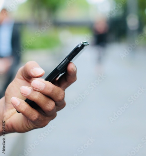 Hand holding a phone outside