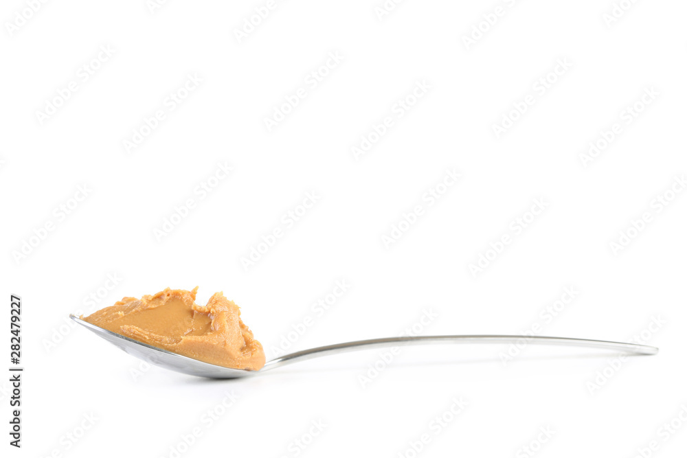 Peanut butter in spoon isolated on white background
