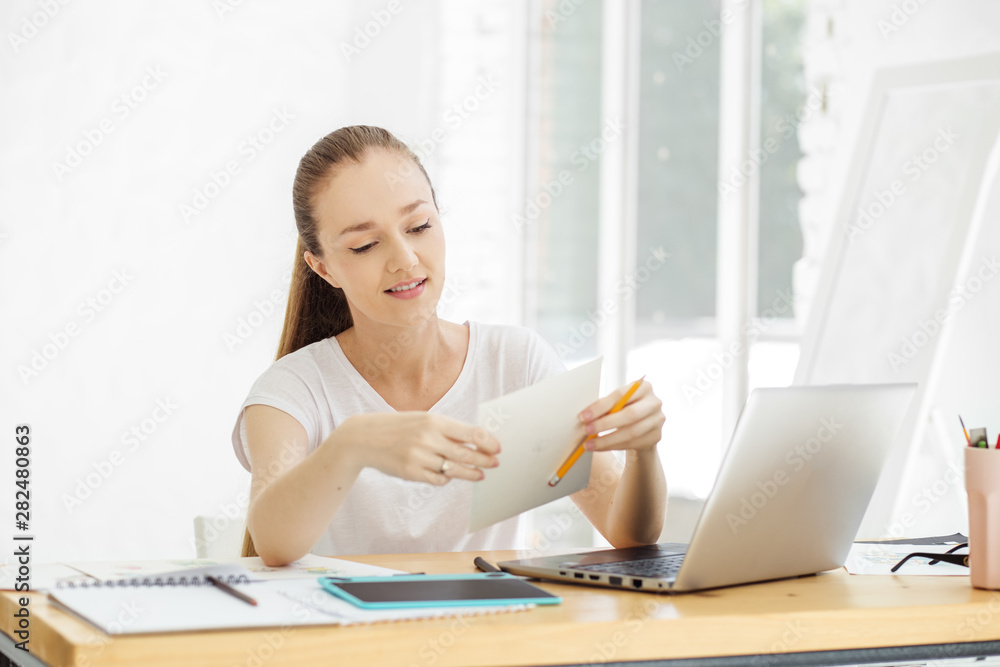 Successful young woman works in the office. Concept for business, work, career. Successful young woman works in the office. Concept for business, work, career.