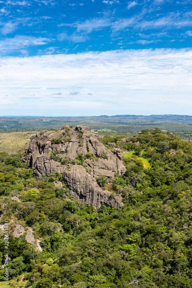 Beautiful aerial view of Serra do Cipo in Minas Gerais with forests and rock mountains in sunny summer day with blue sky. Landscape of the Brazilian Cerrado, one of the most devastated biomes.