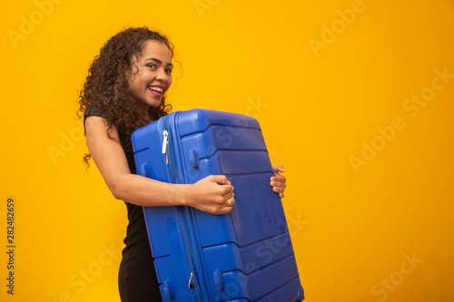 Beautiful curly-haired girl in travel bag. Next trip © Brastock Images