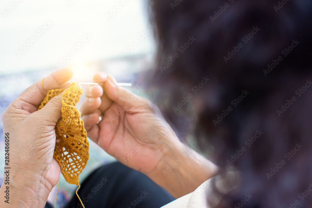 Closeup to hands of old woman doing crochet Closeup to hands of old woman doing crochet