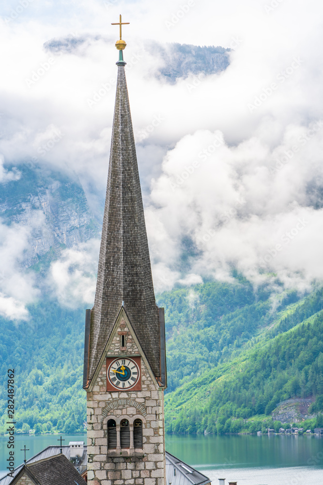Clock tower of Neo Gothic Evangelical Church in Hallstatt on Hallstatter Lake in Salzkammergut region in Austria