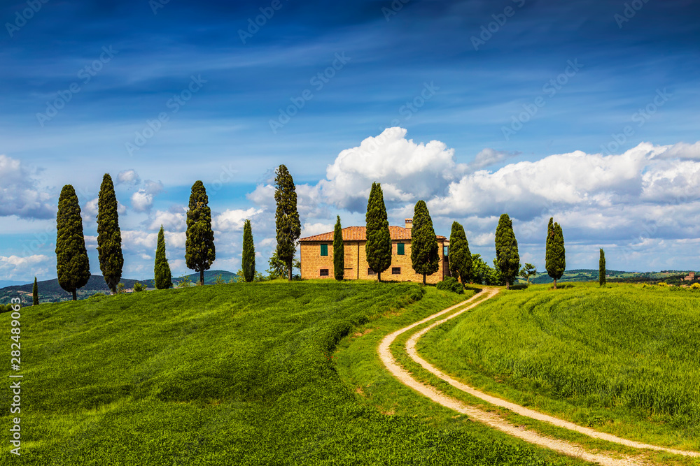 Rural landscape with lonely house and cypresses around, Tuscany, Italy